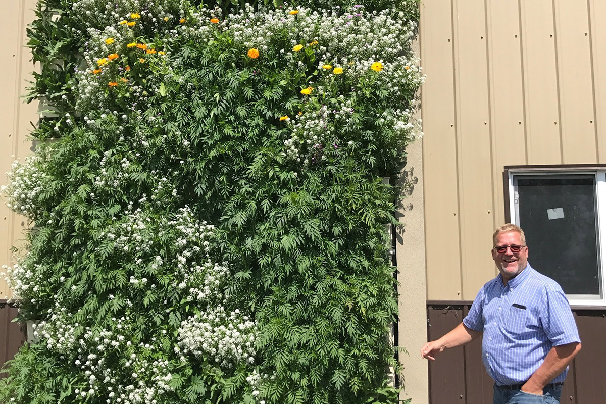 Eric Heuver with his outdoor green wall.