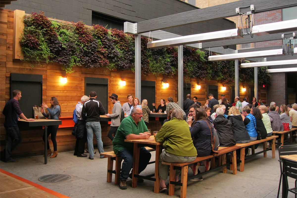 Patrons of New Holland Brewery's Knickerbocker enjoy the outdoor beer garden complete with vertical garden.