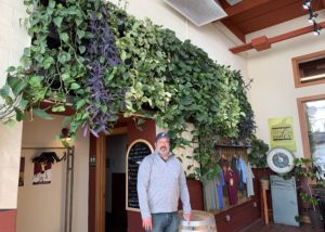 Left Foot Charley owner Bryan Ulbrich standing under his winery's green wall