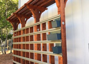 LiveWall fence application using a red wood frame and Cool Blue planter boxes