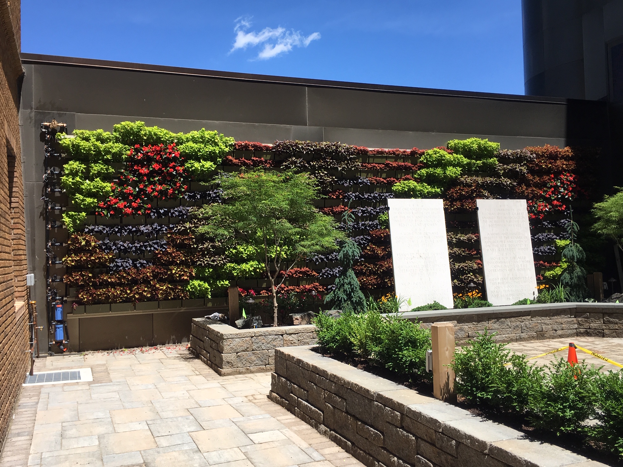 Living wall with colorful blend of annuals in a hospital courtyard
