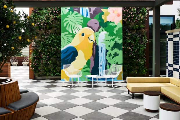 A giant painting of a bird complements the beautiful living wall in Perry Lane Hotel's lobby