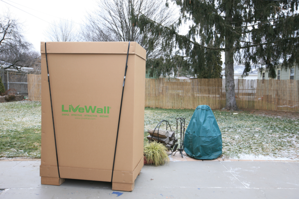 LiveScreen movable green wall system on wheels in the packaging it's shipped in